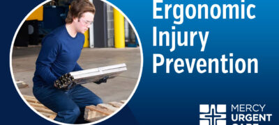 A man dressed all in blue and safety goggles bending from the knee to pick up metal bars.